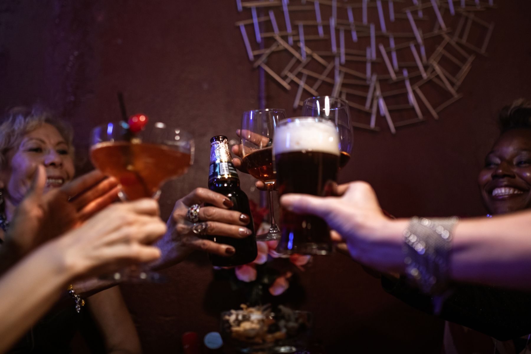 Friends toasting drinks bar planning