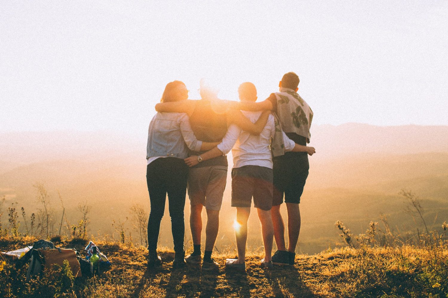 group hugging and watching the sunset during a hike